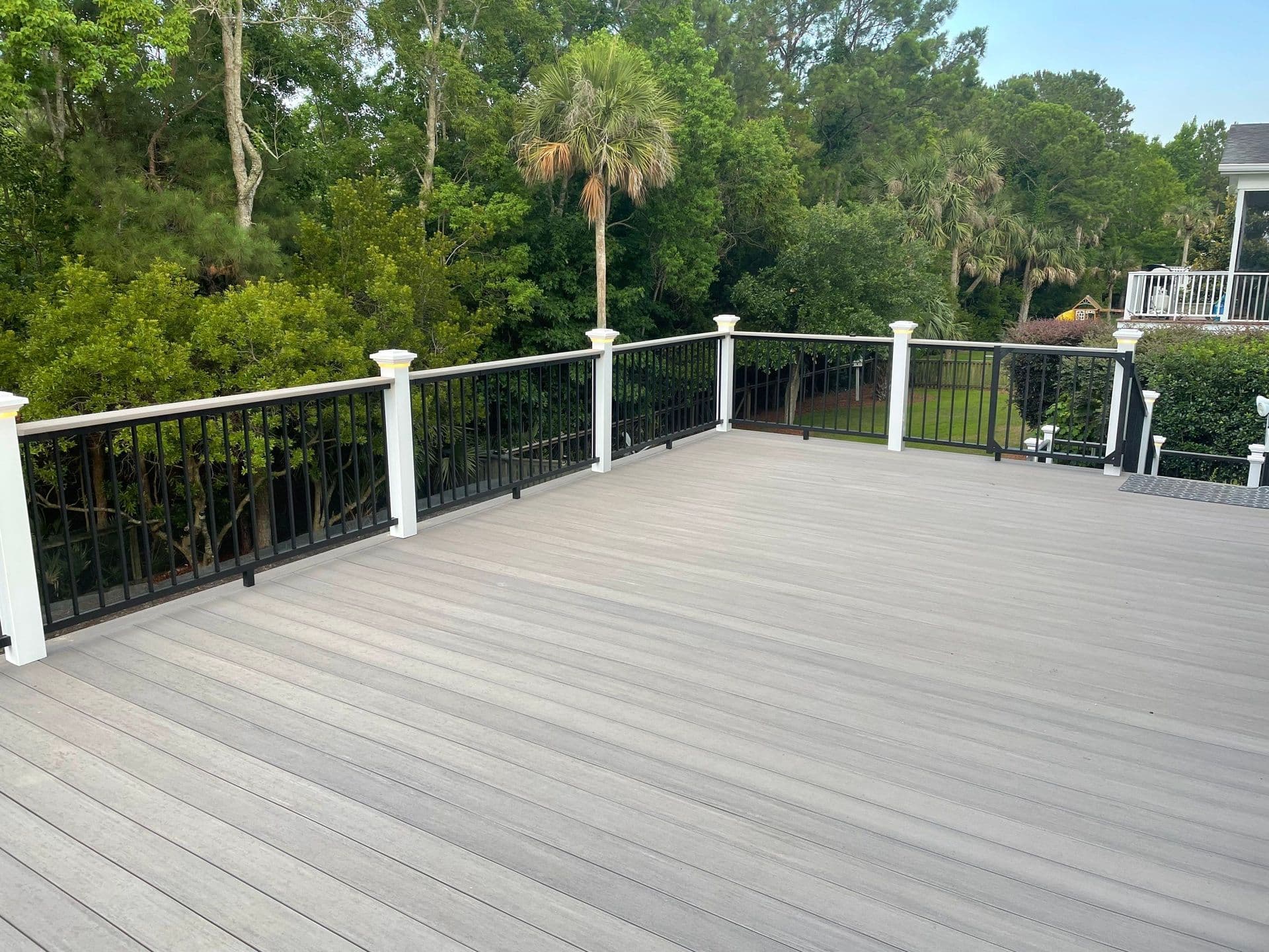 A photo of a light gray TimberTech deck with white posts and black metal railings in Mount Pleasant, South Carolina.